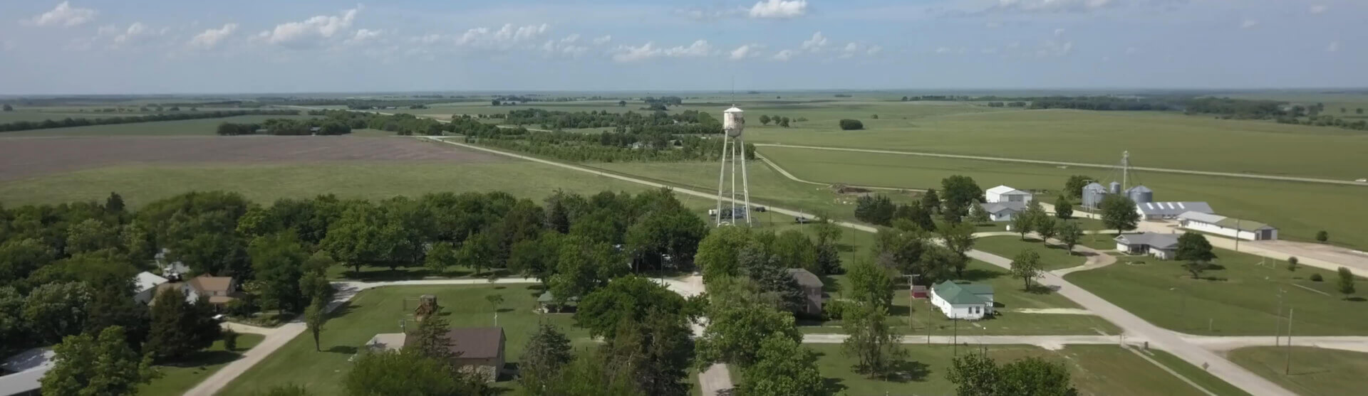 Rural farm scene with grain silos and small white water tower