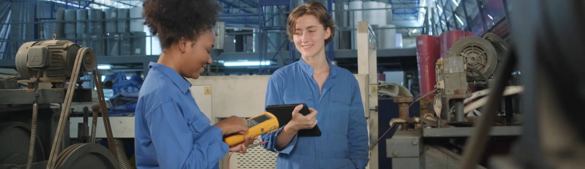 two workers in blue with work tablets